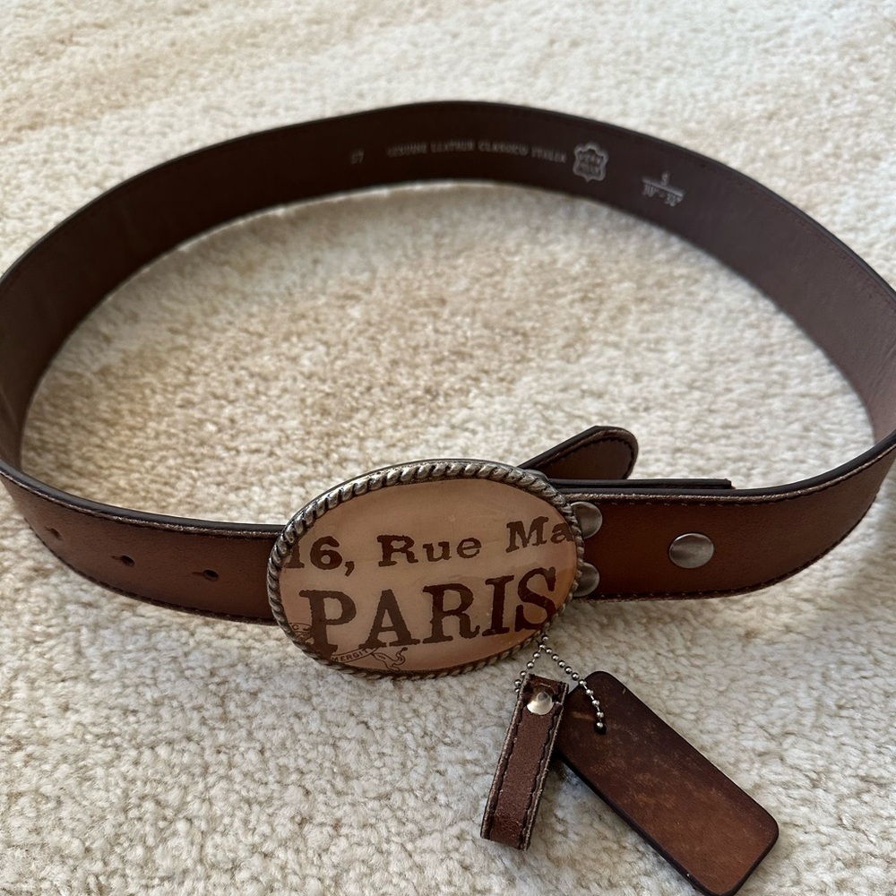 Genuine leather belt with “Paris” buckle. Belt is new / never worn.